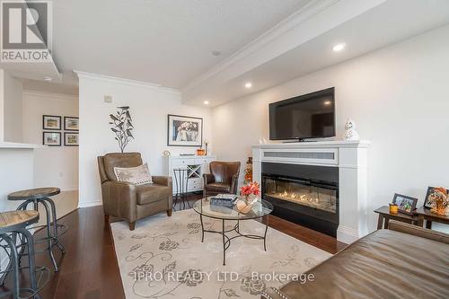 208 - 200 Halton Hills Drive, Halton Hills (Georgetown), ON - Indoor Photo Showing Living Room With Fireplace