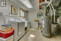Laundry Room with Owned Water Heater and Heat Pump - 