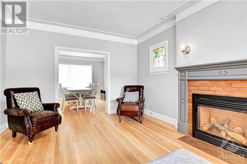 Main Floor - Living Room view to Dining Room - 22-24 Byron Avenue, Ottawa, ON - Indoor Photo Showing Living Room With Fireplace