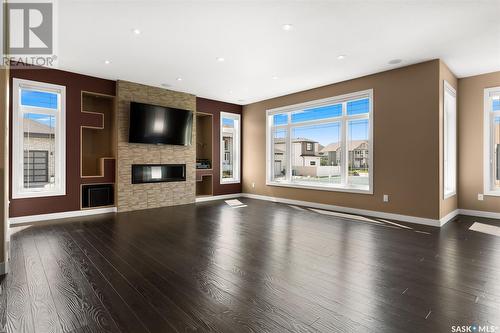 4213 Green Rose Crescent E, Regina, SK - Indoor Photo Showing Living Room With Fireplace