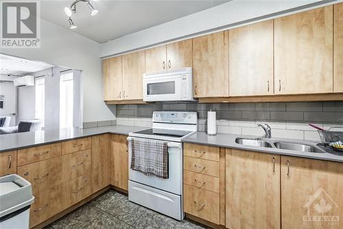 3100 Carling Avenue Unit#219, Ottawa, ON - Indoor Photo Showing Kitchen With Double Sink