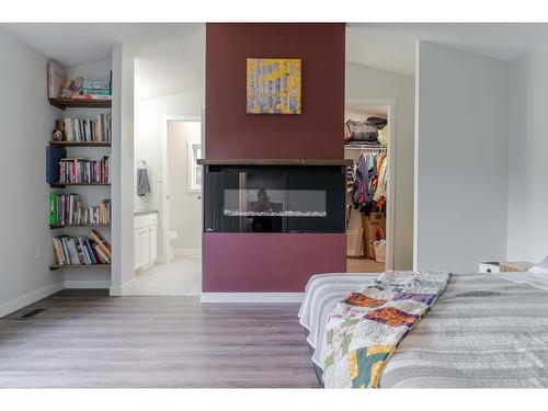 8144 Highway 3/93, Cranbrook, BC - Indoor Photo Showing Bedroom With Fireplace