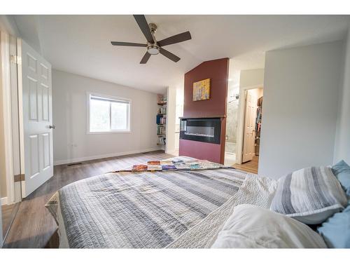 8144 Highway 3/93, Cranbrook, BC - Indoor Photo Showing Bedroom With Fireplace