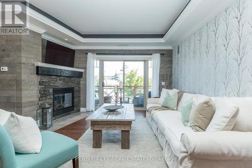 204 - 130 Steamship Bay Road, Gravenhurst, ON - Indoor Photo Showing Living Room With Fireplace