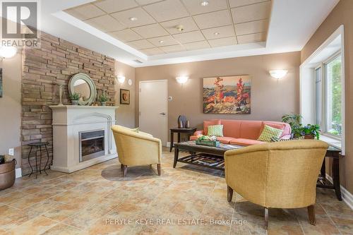 204 - 130 Steamship Bay Road, Gravenhurst, ON - Indoor Photo Showing Living Room With Fireplace