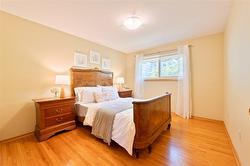 Large primary bedroom with hardwood floor - 