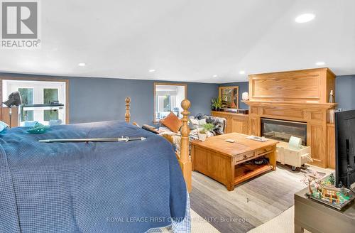 63 Idlewood Drive, Springwater (Midhurst), ON - Indoor Photo Showing Bedroom With Fireplace