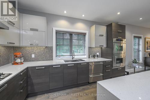 sleek, 2- tone, flat-panel high gloss cabinetry - 1 - 570 Windermere Road, London, ON - Indoor Photo Showing Kitchen With Double Sink With Upgraded Kitchen