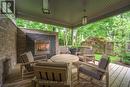 covered back deck with gas fireplace, mature trees - 1 - 570 Windermere Road, London, ON  - Outdoor With Deck Patio Veranda With Exterior 