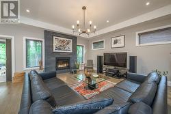 spacious living room with fireplace & tray ceiling - 