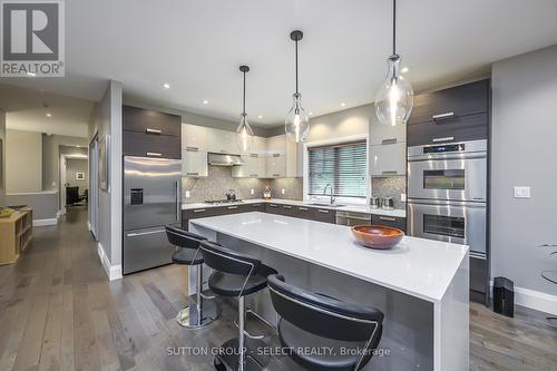 centre island with quartz waterfall surface - 1 - 570 Windermere Road, London, ON - Indoor Photo Showing Kitchen With Upgraded Kitchen