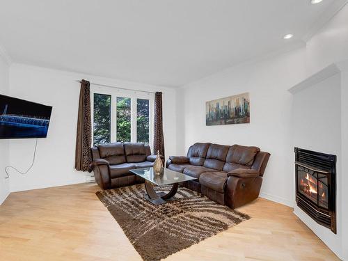 Living room - 3425 Ch. De La Rivière-Cachée, Boisbriand, QC - Indoor Photo Showing Living Room With Fireplace