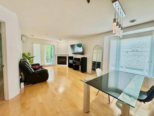 View - 202-2160 Rue Bonaventure, Laval (Sainte-Dorothée), QC - Indoor Photo Showing Living Room With Fireplace