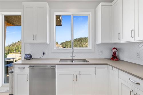 1888 Northern Flicker Court, Kelowna, BC - Indoor Photo Showing Kitchen With Double Sink