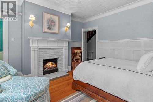 152 Water Street, Carbonear, NL - Indoor Photo Showing Bedroom With Fireplace