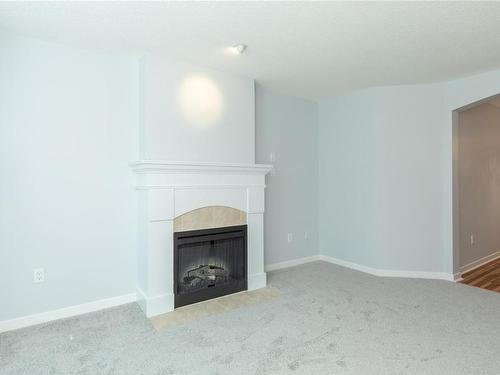 207-5660 Edgewater Lane, Nanaimo, BC - Indoor Photo Showing Other Room With Fireplace