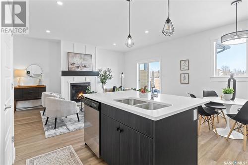 58 900 St Andrews Lane, Warman, SK - Indoor Photo Showing Kitchen With Fireplace With Double Sink