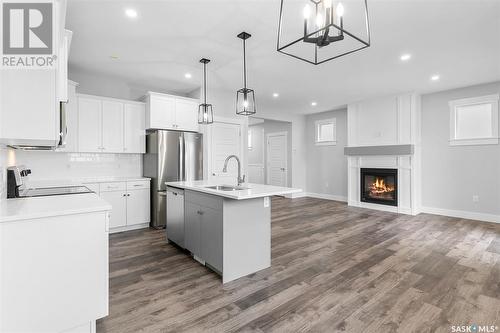 57 900 St Andrews Lane, Warman, SK - Indoor Photo Showing Kitchen With Fireplace With Upgraded Kitchen