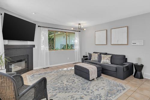3945 Suncrest Court, Kelowna, BC - Indoor Photo Showing Living Room With Fireplace