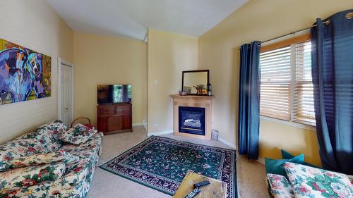 1880A Kootenay Avenue, Rossland, BC - Indoor Photo Showing Bedroom With Fireplace