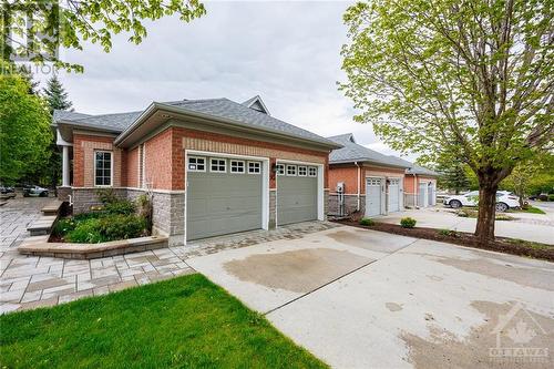 Hardwood floors, vaulted ceiling and gas fireplace in spacious living room. - 93 Kinmount Private, Ottawa, ON - Indoor