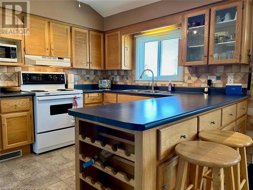 With anchored breakfast bar and loads of storage. - 5 Mill Point Road, North Bruce Peninsula, ON - Indoor Photo Showing Kitchen With Double Sink