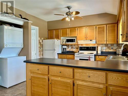 Stacked laundry. - 5 Mill Point Road, North Bruce Peninsula, ON - Indoor Photo Showing Kitchen With Double Sink