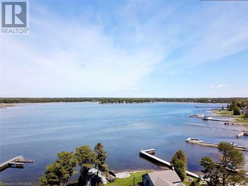 Mill Point is at the mouth of popular Pike Bay on Lake Huron offering excellent deep water boat docking. - 5 Mill Point Road, North Bruce Peninsula, ON - Outdoor With Body Of Water With View