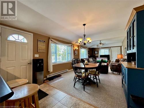 Front entrance offers a tile stone foyer in the open concept great room area.  2nd entrance off living room to wrap around decking to waterside. - 5 Mill Point Road, North Bruce Peninsula, ON - Indoor Photo Showing Dining Room