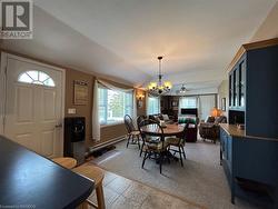 Ample sized dining area with large windows and view of the wood stove - fireplace. - 