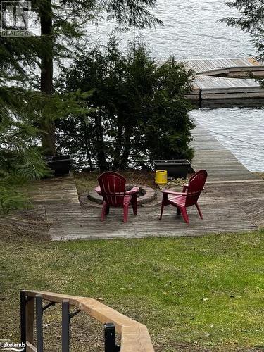 View from deck towards lakeside fire pit - 1016 Pegg Drive, Haliburton, ON - Outdoor With Body Of Water