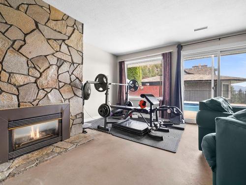 960 Augusta Court, Kelowna, BC - Indoor Photo Showing Gym Room With Fireplace