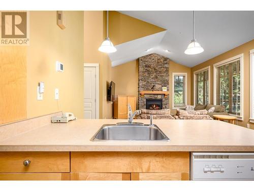 251 Predator Ridge Drive Unit# 47, Vernon, BC - Indoor Photo Showing Kitchen With Fireplace