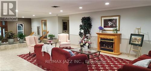204 - 1 Heritage Way, Kawartha Lakes, ON - Indoor Photo Showing Living Room With Fireplace