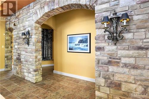 Custom natural stone accents echo the rocky terrain. - 325 Berry Side Road, Kanata, ON - Indoor Photo Showing Other Room
