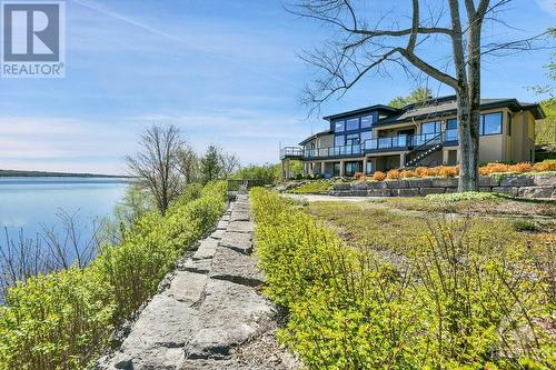 Substantial landscaping has been done using natural armour stone in keeping with the natural terrain. - 325 Berry Side Road, Kanata, ON - Outdoor With Body Of Water With View