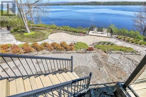 Trex decking and stairs lead to tiered outdoor living spaces. - 325 Berry Side Road, Kanata, ON - Outdoor With Body Of Water With View