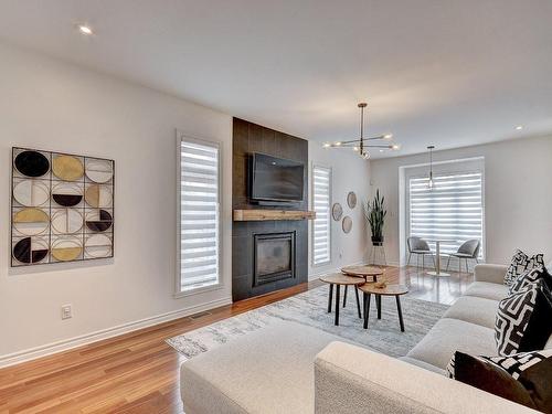 Living room - 115 Rue De La Terre-De-Feu, La Prairie, QC - Indoor Photo Showing Living Room With Fireplace