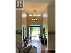 Grand Foyer has 13' ceiling & lots of light from shed dormer windows - 