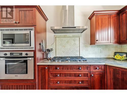 5 burner gas stove top beside built in oven & microwave - 2726 Golf Course Drive, Blind Bay, BC - Indoor Photo Showing Kitchen