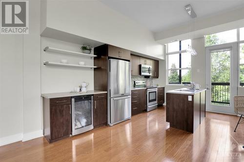 Galley kitchen with hard wood floors. - 345 St Denis Street Unit#210, Ottawa, ON - Indoor Photo Showing Kitchen