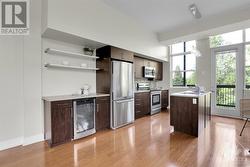 Galley kitchen with hard wood floors. - 