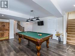 Note the handy stairs at the end of the games room to give you easy access to the garage. Note new flooring being installed. - 