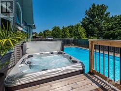 Hot tub deck perfectly located right by the Kitchen patio doors so you have easy access in the winter. - 