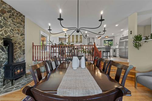 1258 Round Lake Road, Spallumcheen, BC - Indoor Photo Showing Dining Room With Fireplace