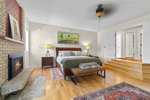 1258 Round Lake Road, Spallumcheen, BC - Indoor Photo Showing Bedroom With Fireplace