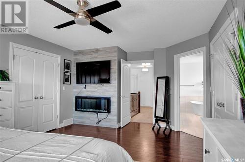 45 Emerald Creek Drive, White City, SK - Indoor Photo Showing Bedroom With Fireplace