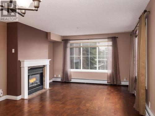 201 1638 6Th Avenue, Prince George, BC - Indoor Photo Showing Living Room With Fireplace