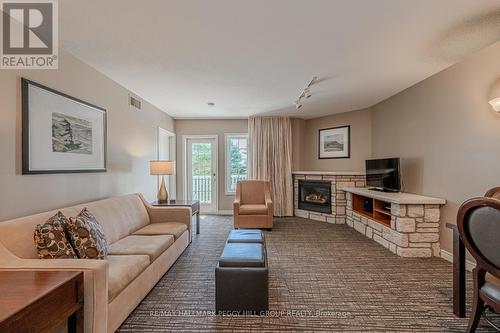 2220-21 - 90 Highland Drive, Oro-Medonte (Horseshoe Valley), ON - Indoor Photo Showing Living Room With Fireplace