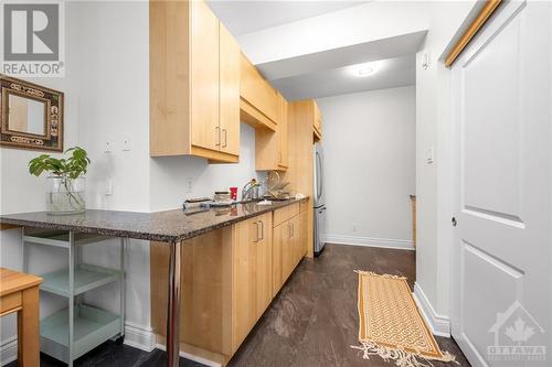 Stone countertops and in suite laundry. - 303 Lanark Avenue, Ottawa, ON - Indoor Photo Showing Other Room